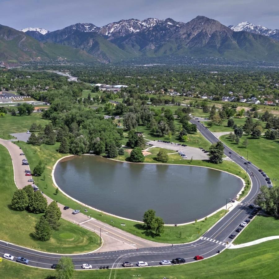 a lake surrounded by trees and buildings