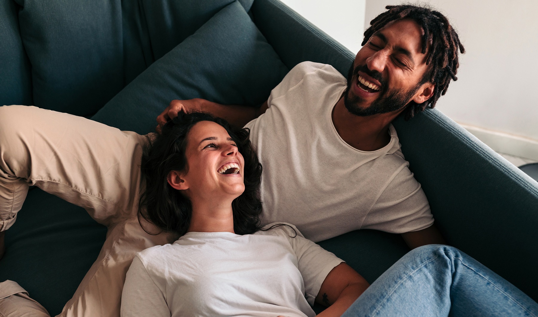 a couple indoors laughing