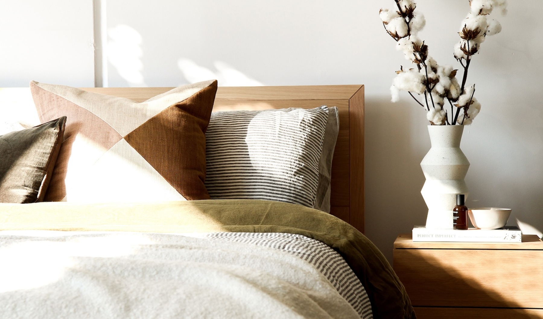 a made bed in a bright room